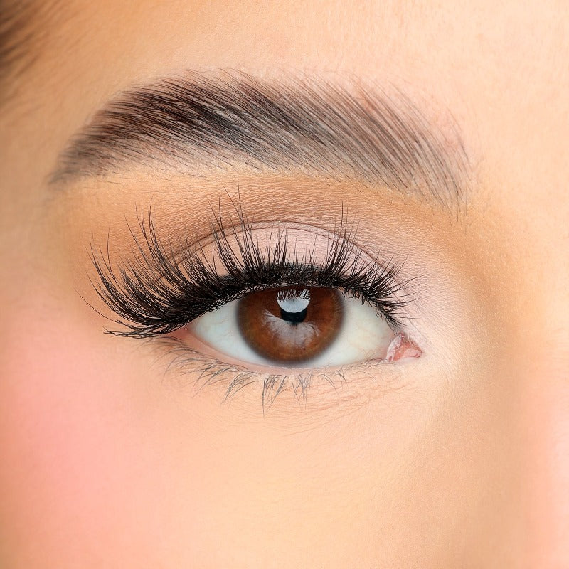 Lash swatch of a pair of super wispy and mega volume faux mink vegan fluffy and lightweight lashes on a white woman with brown eyes